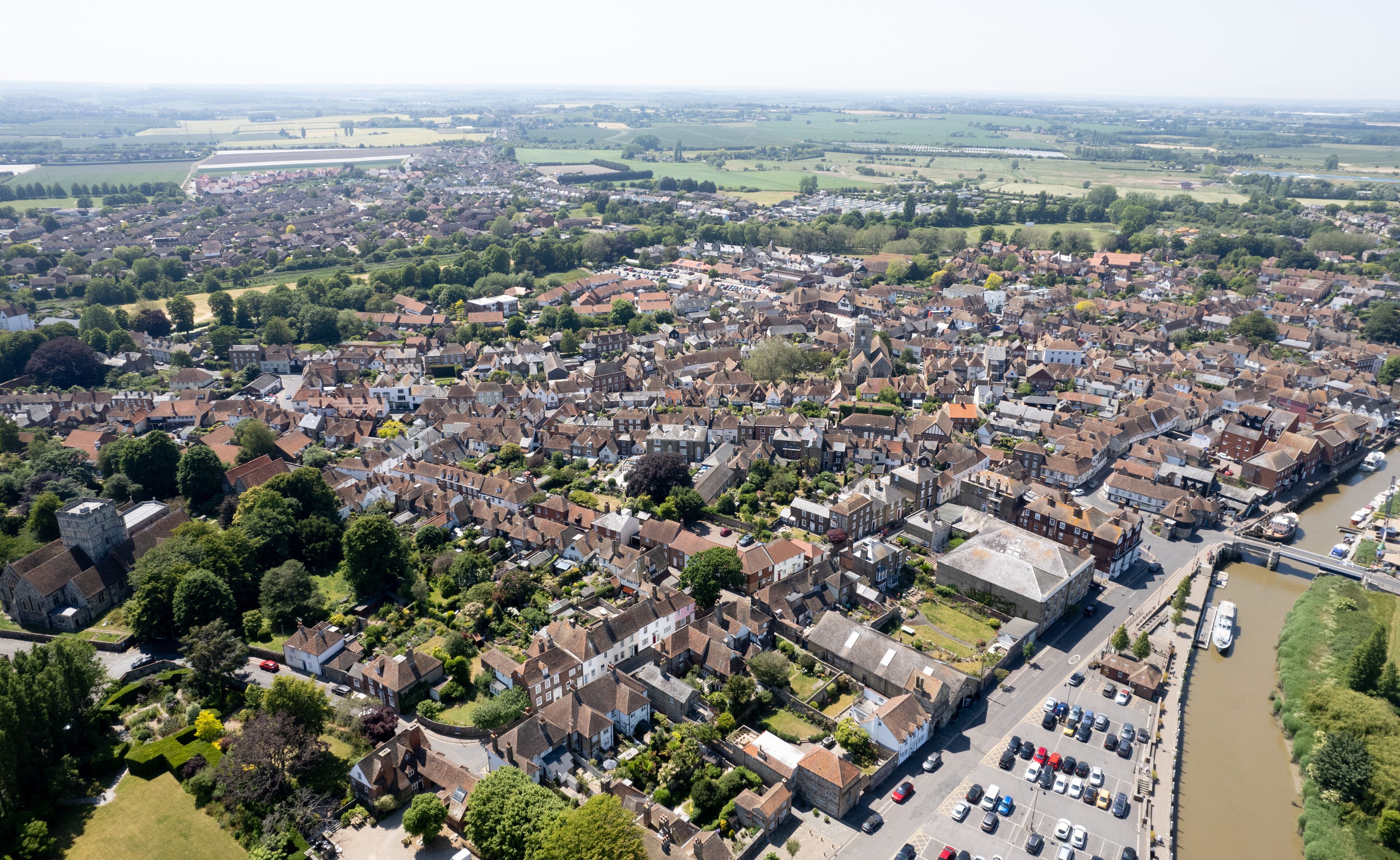 An aerial view of a densely populated town with a river running through it.