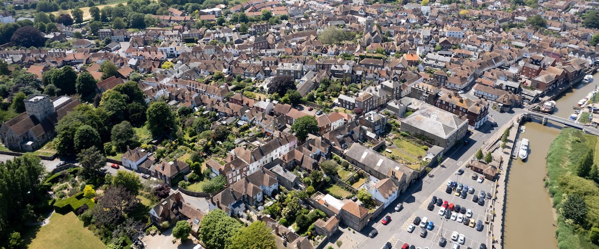 An aerial view of a densely populated town with a river running through it.