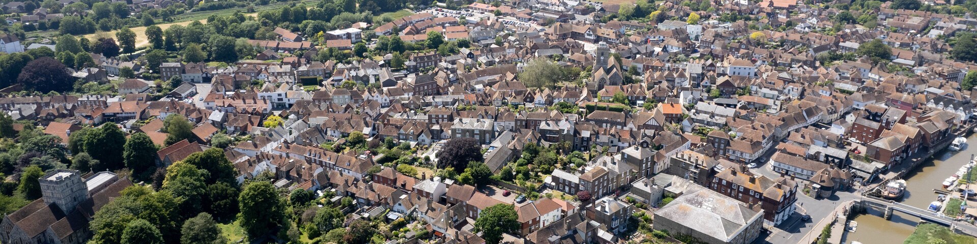 An aerial view of a densely populated town with a river running through it.