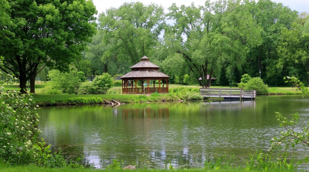 Midwest nature background with city park view. Beautiful late spring landscape with trees around the pond and wooden gazebo in a city park. Lakeview park, Middleton, Madison area, WI, USA.