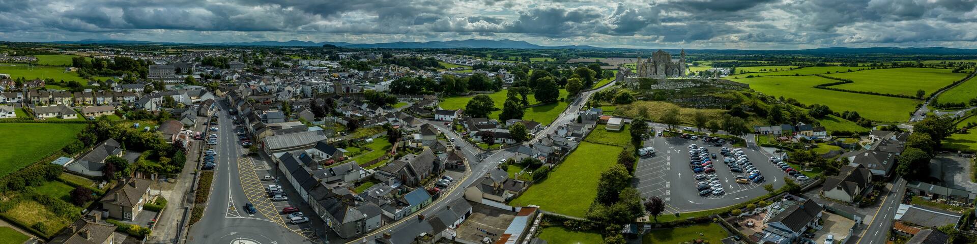 Aerial panorama of Cashel town , Rock of Cashel iconic Irish historic landmark with Romanesque chapel, a Gothic cathedral, an abbey, the Hall of the Vicars Choral and a fifteenth-century Tower House