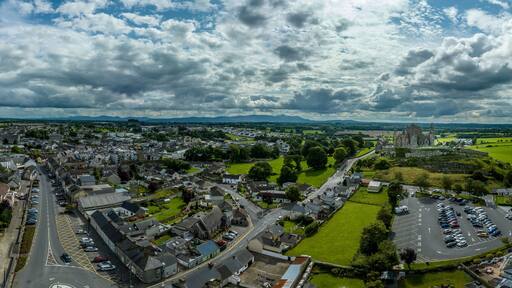 Aerial panorama of Cashel town , Rock of Cashel iconic Irish historic landmark with Romanesque chapel, a Gothic cathedral, an abbey, the Hall of the Vicars Choral and a fifteenth-century Tower House