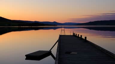 Norwegian lake at sunset with silhouette of pier, Jevnaker, Norway