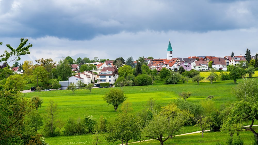 Germany, Dreamy town ostfildern kemant behind green nature countryside in spring