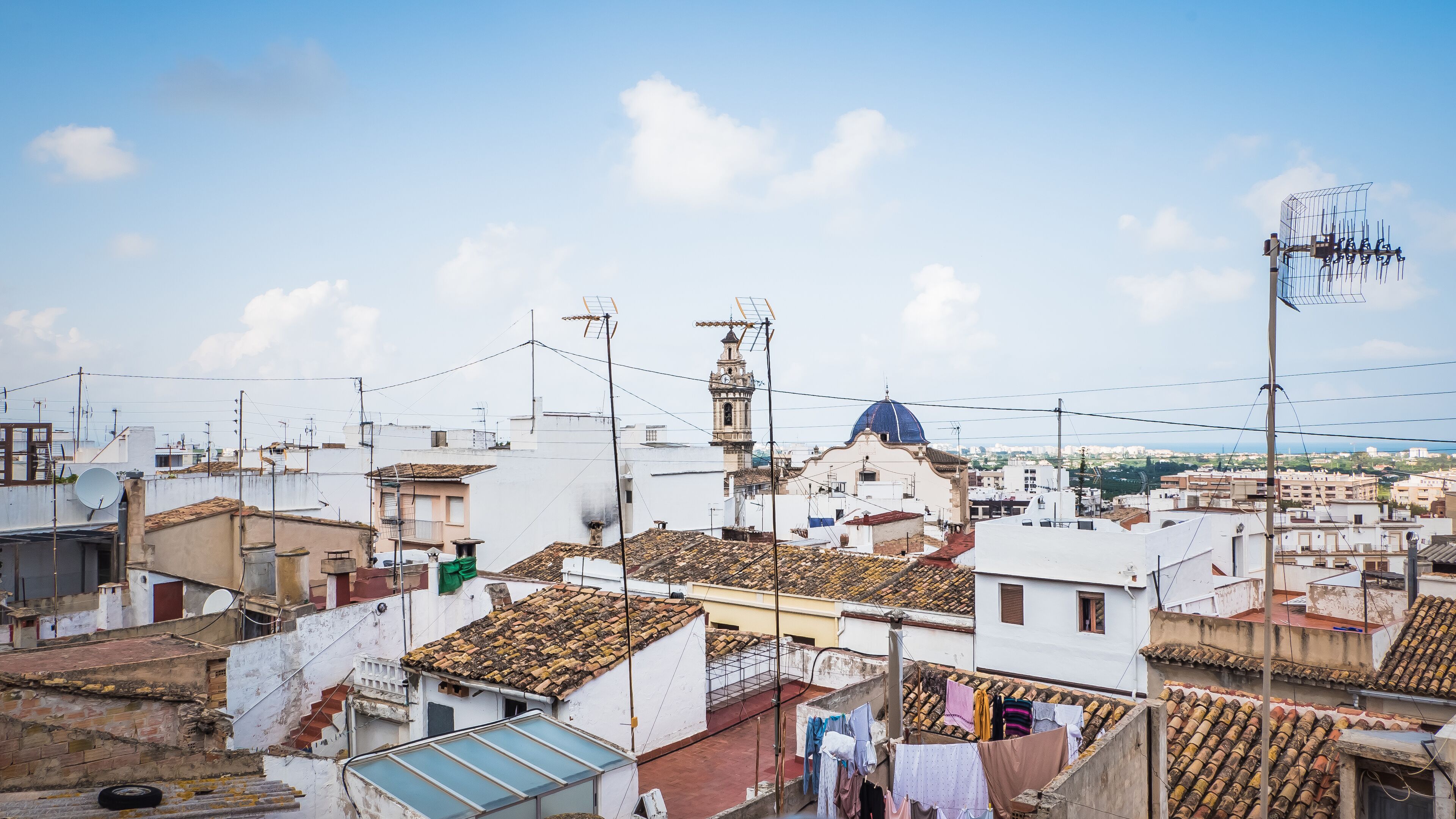 Aerial view of old town Oliva, Valencia, Spain. A panoramic view of narrow streets and old Moorish type houses in white color with old churches, Iglesia Santa Mara la Mayor and Parroquia de San Roque,