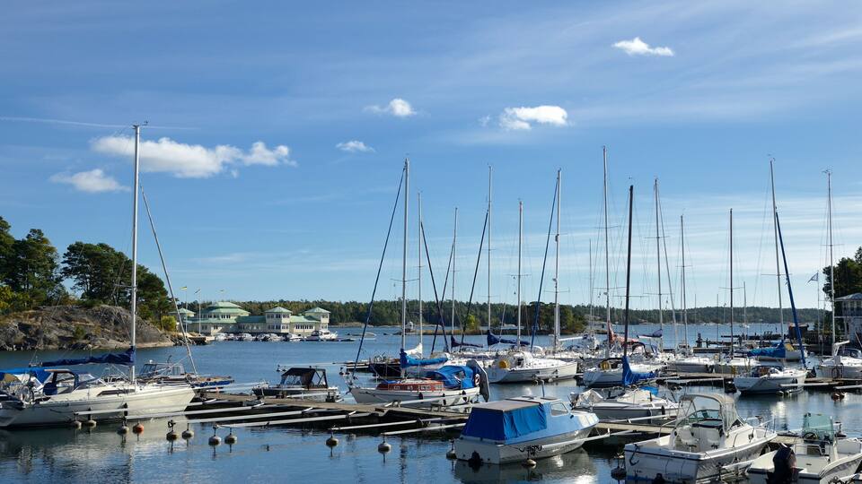 A marina with various sailboats and yachts docked.