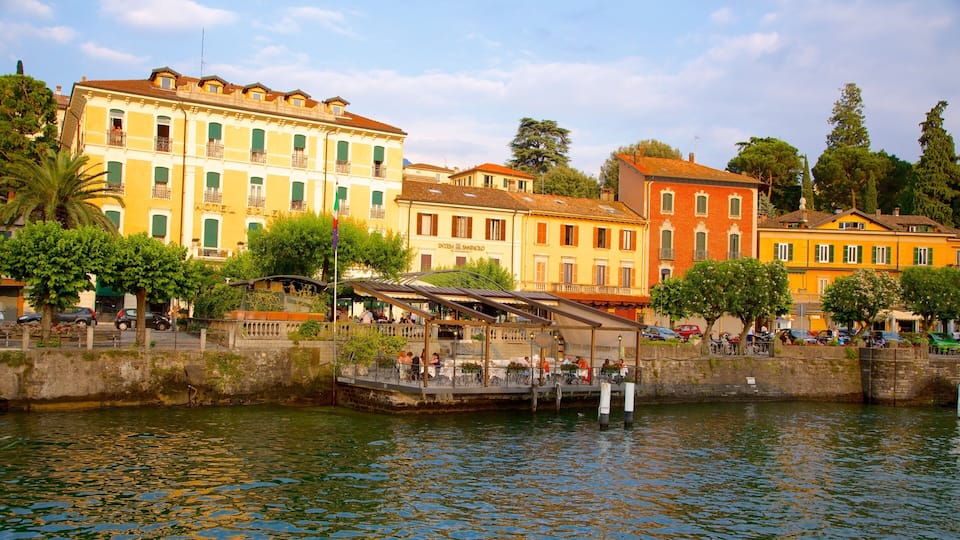 A waterfront with historic buildings, a bridge, and a cafƩ.