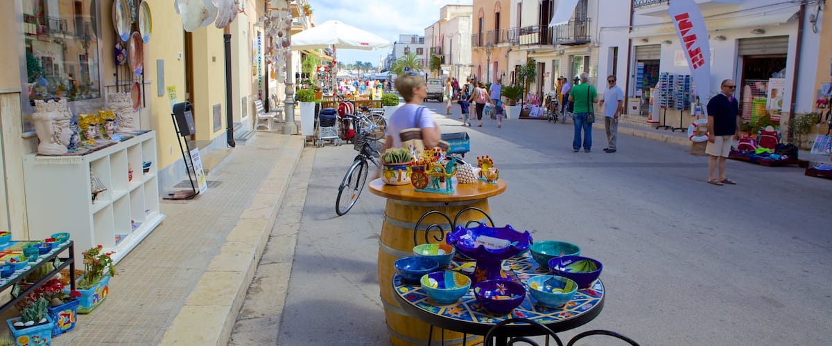 A bustling street market with colorful pottery and a variety of stalls.