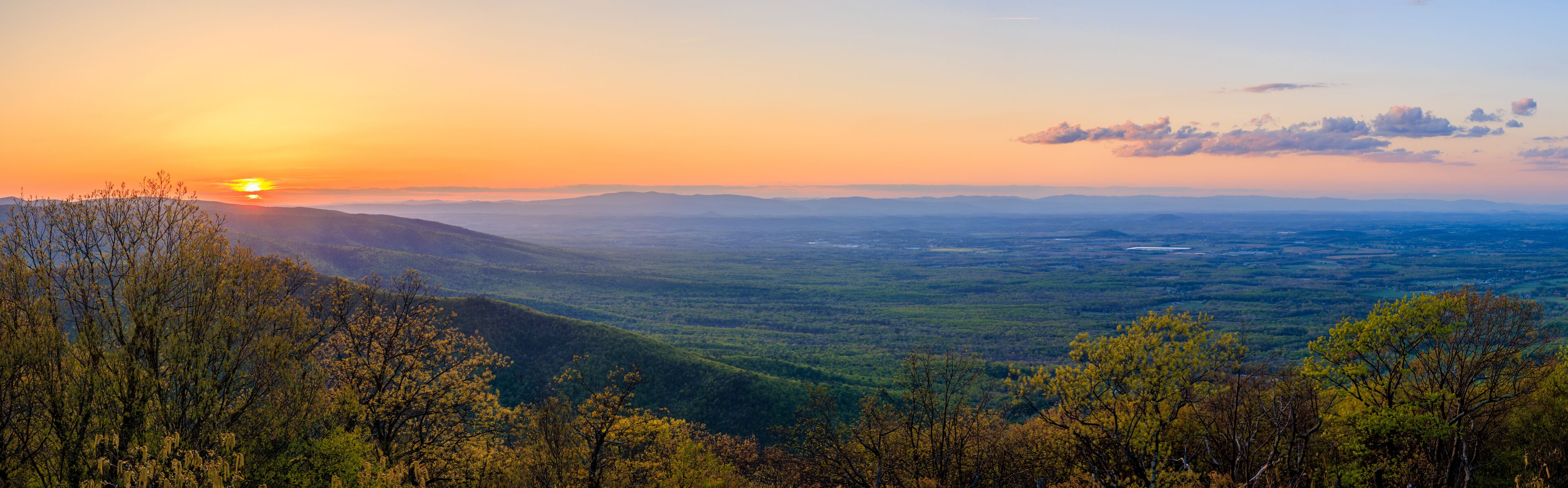 A mountainous landscape with a sunset.