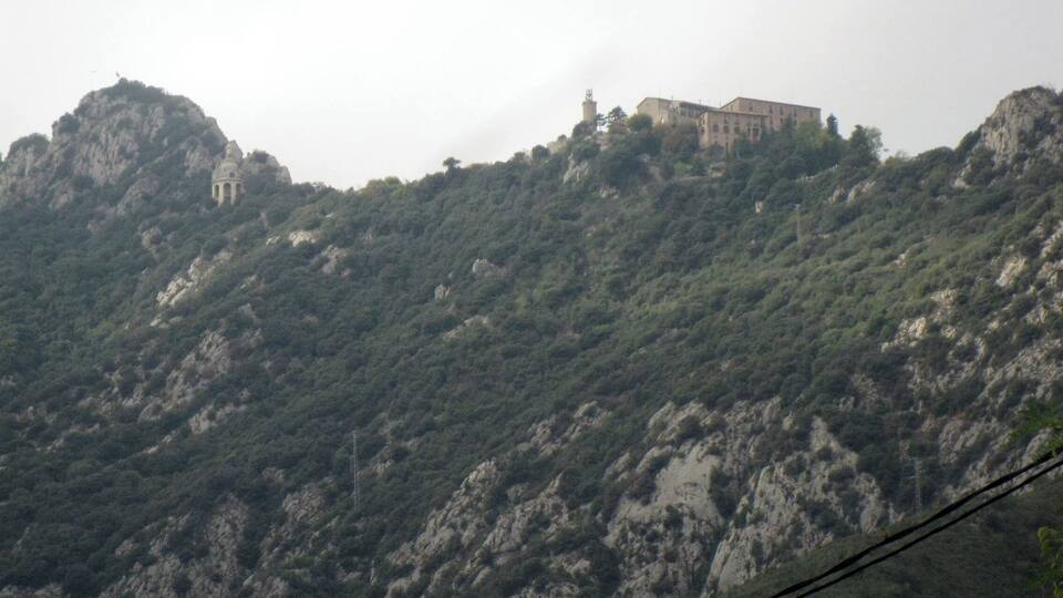 A mountainous landscape with a building on top.