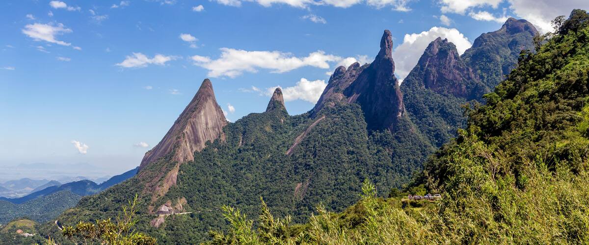 A mountainous landscape with prominent peaks and lush greenery.