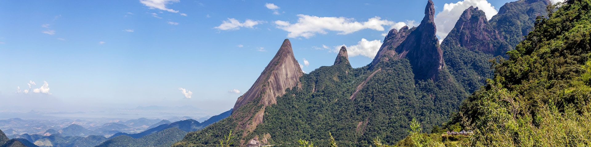 A mountainous landscape with prominent peaks and lush greenery.