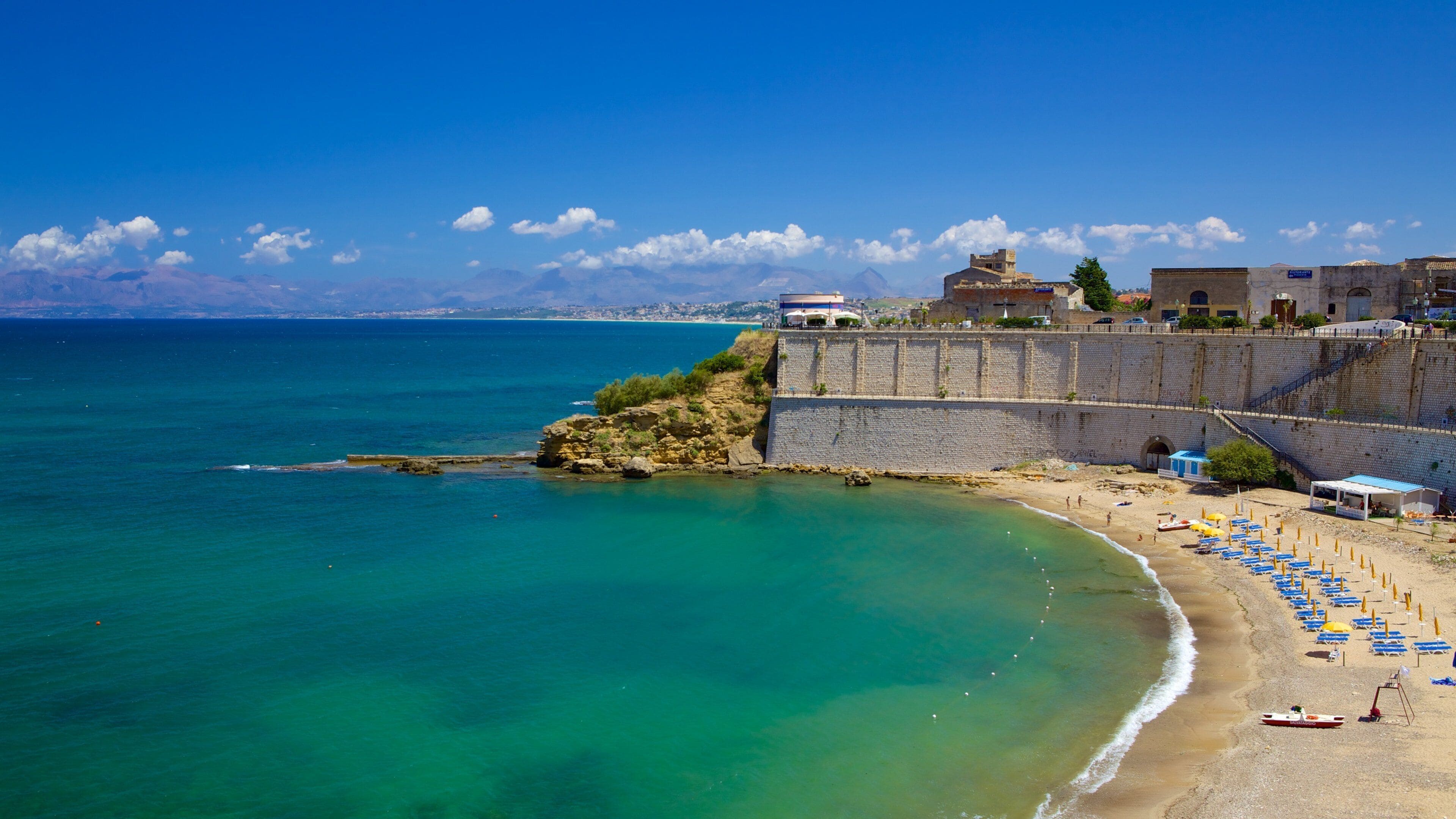 Castellammare del Golfo which includes a sandy beach and rugged coastline