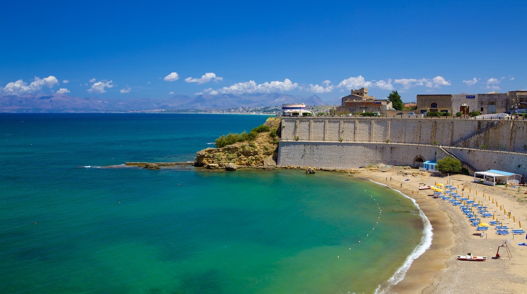 Castellammare del Golfo which includes a sandy beach and rugged coastline