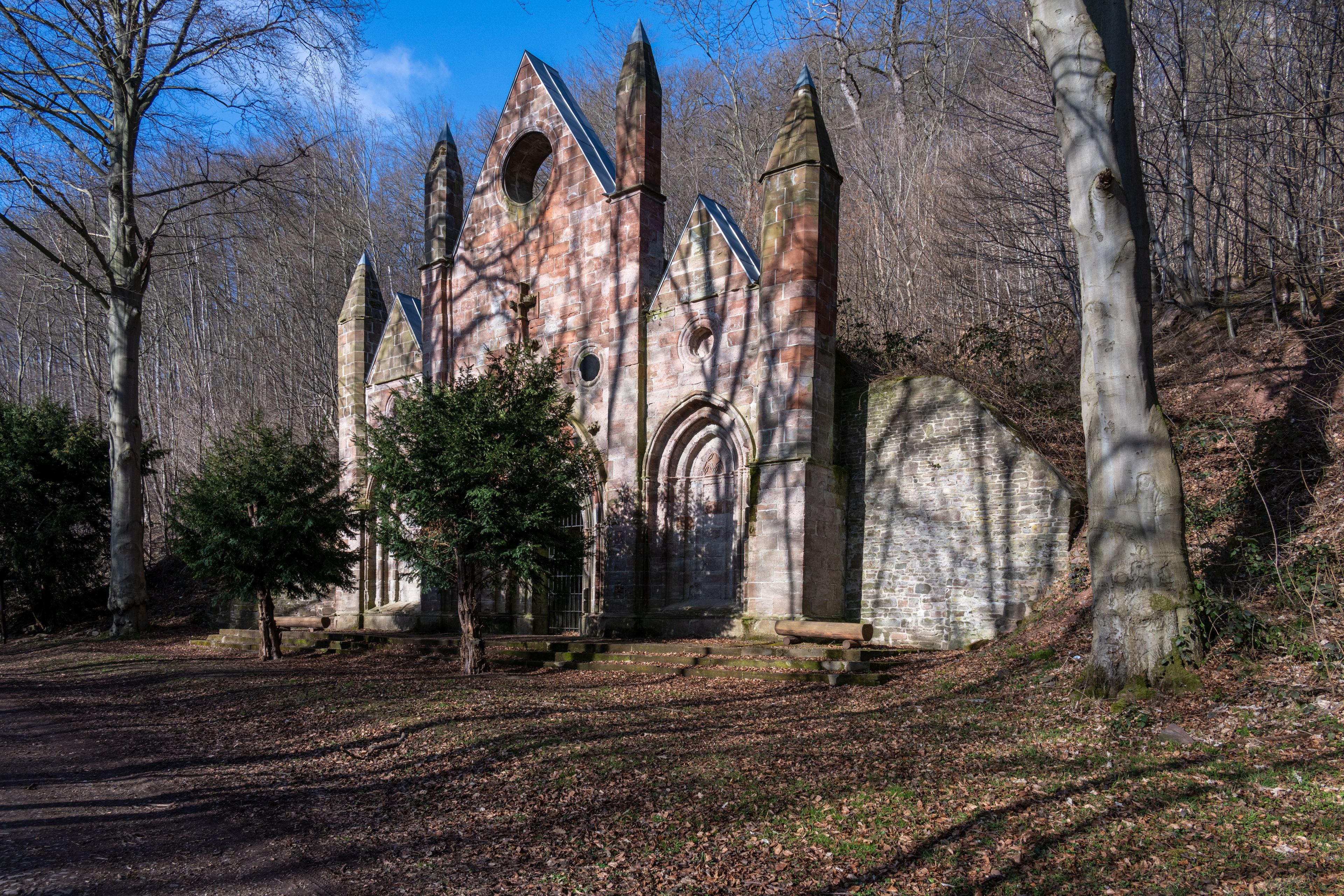 An old stone church with pointed spires and a large arched entrance.