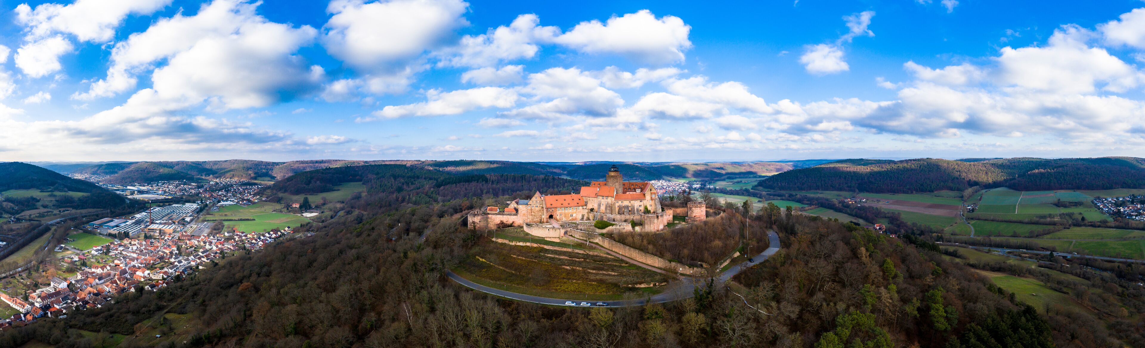 A castle on a hill overlooking a town.