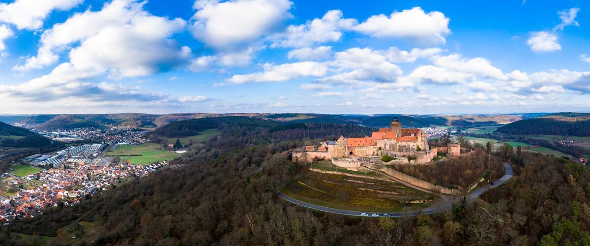 A castle on a hill overlooking a town.