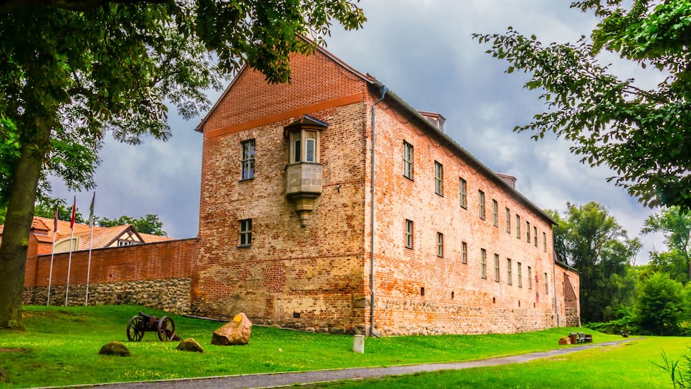 The old castle Storkow in Brandenburg Germany was built in the middle of the 12th century. The west side of the castle with bay window and cannon.