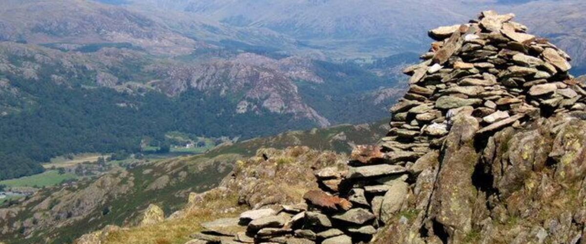 Summit cairn of Stickle Pike Looking north to Esk Pike, Bowfell and Crinkle Crags.
