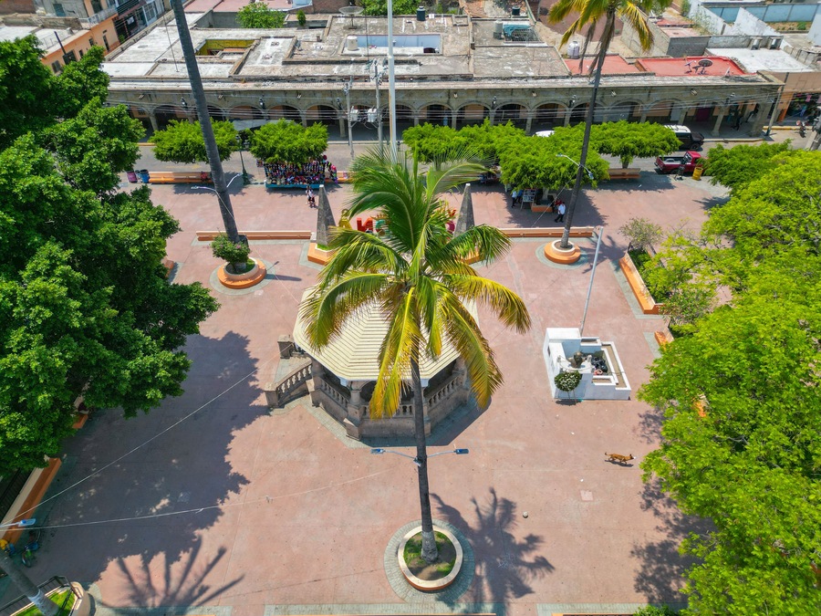 Drone shot capturing the charm of the central square in Villa Corona, including its traditional kiosk and urban surroundings