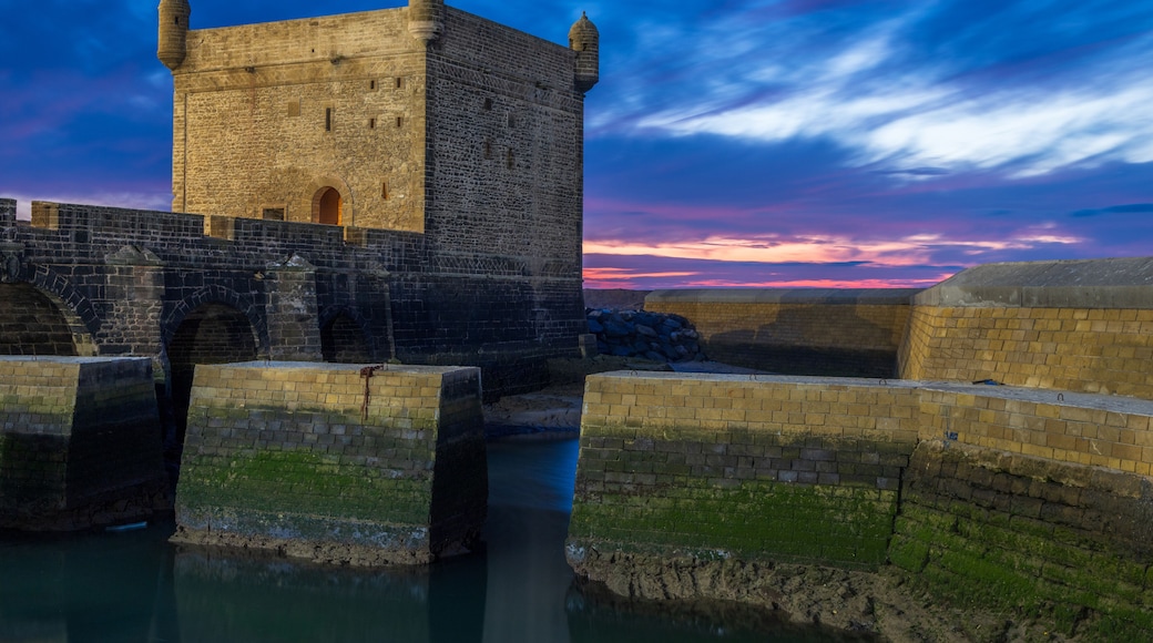 Port of Essaouira Sqala, Portuguese castle in a sunset lights with stone wall and moat in the foreground, Essaouira, Morocco