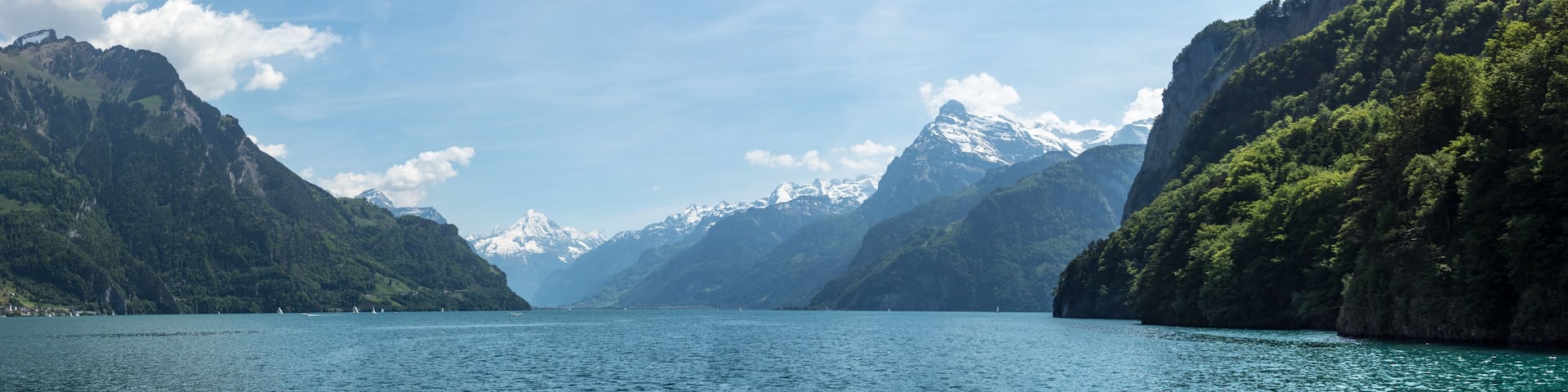 panoramic view into the swiss alps on a boat cruise on lake lucerne end of spring