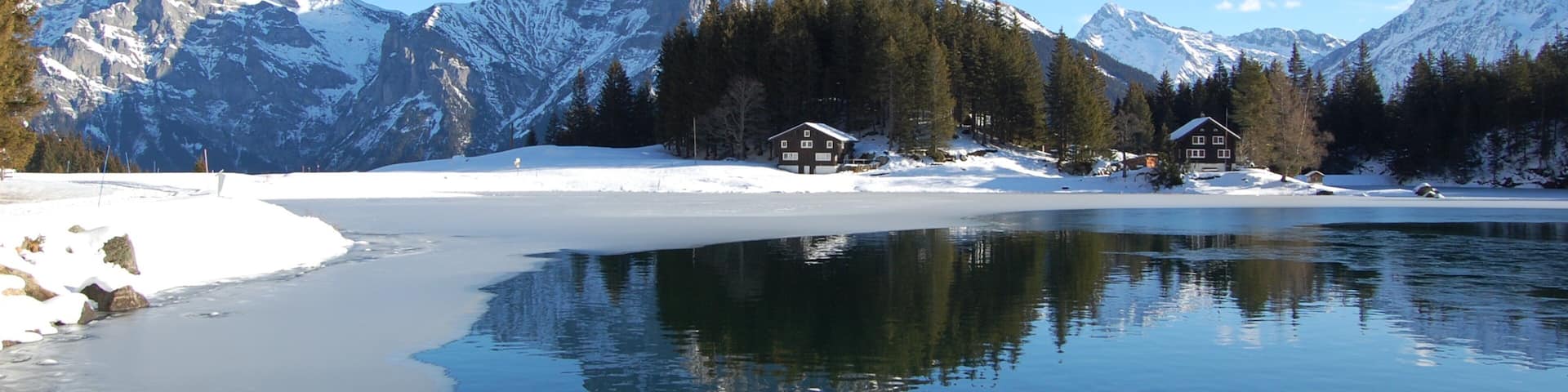 Andermatt which includes mountains, a lake or waterhole and landscape views