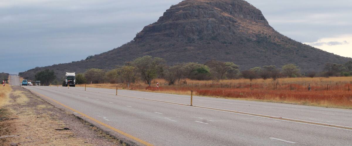 A highway with a mountain in the background.