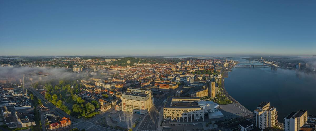 Panoramic aerial view of Aalborg city with House of Music and Aalborg port in the early morning with fog, Denmark