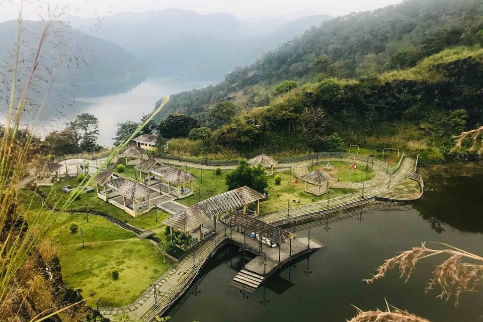 A park with a lake, walking paths, and several gazebos.