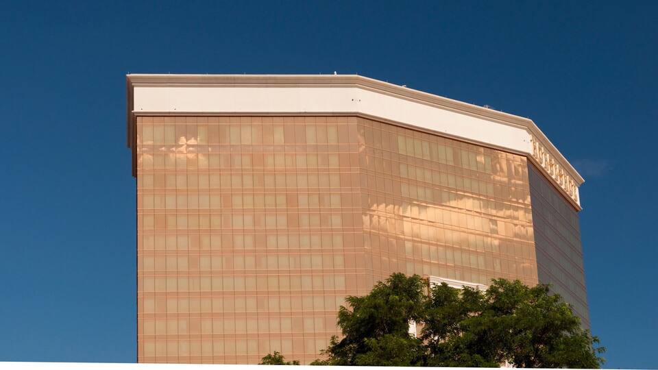 A modern building with a glass facade and a moon in the sky.