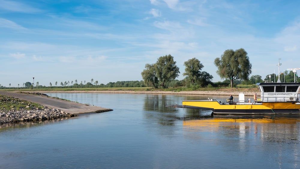 yellow ferry on river ijssel between olburgen and dieren in gelderland