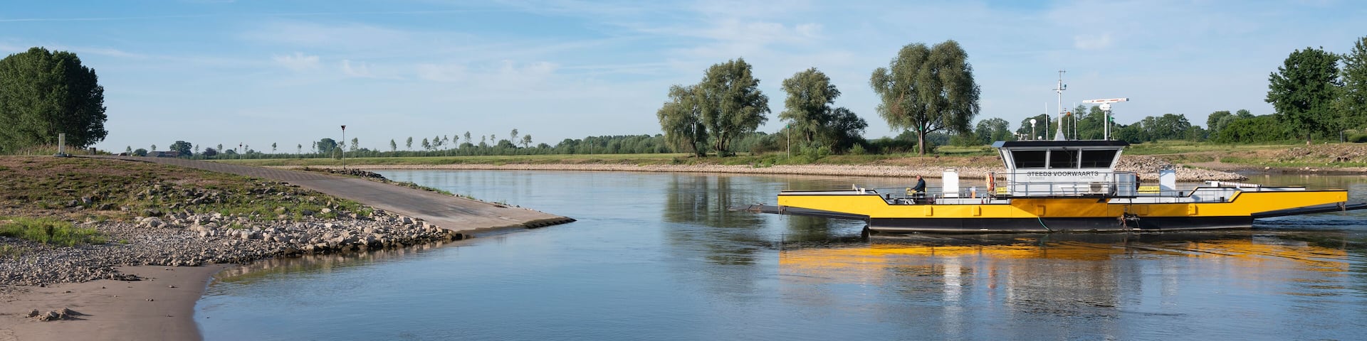 yellow ferry on river ijssel between olburgen and dieren in gelderland