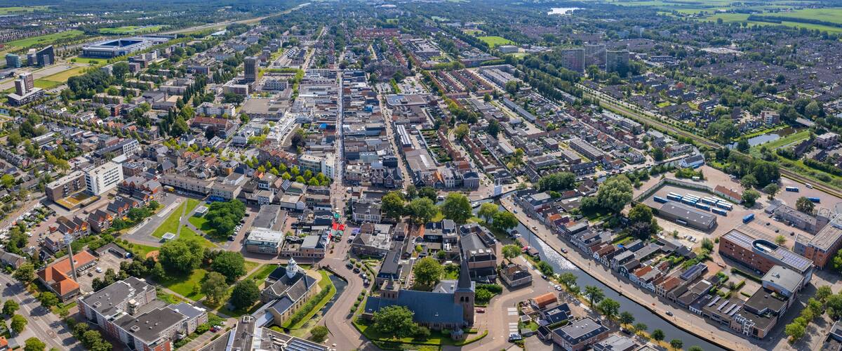 An aerial view of a densely populated urban area with a river running through it.