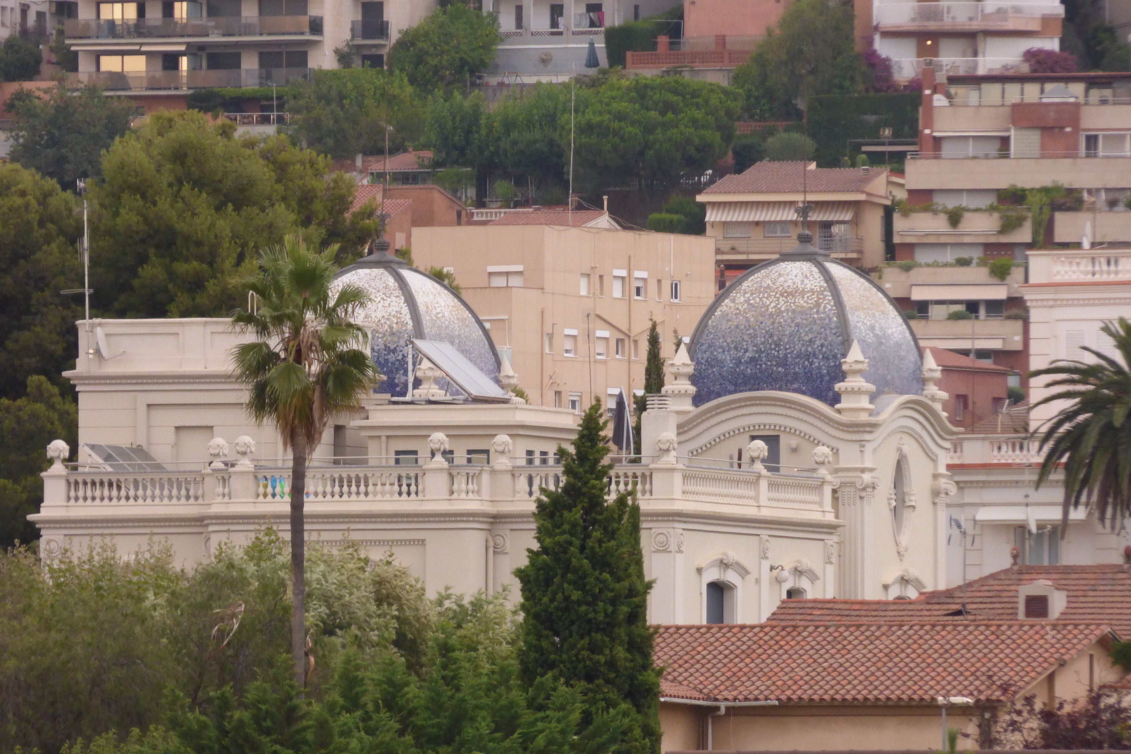 A building with two large domes and a white facade.