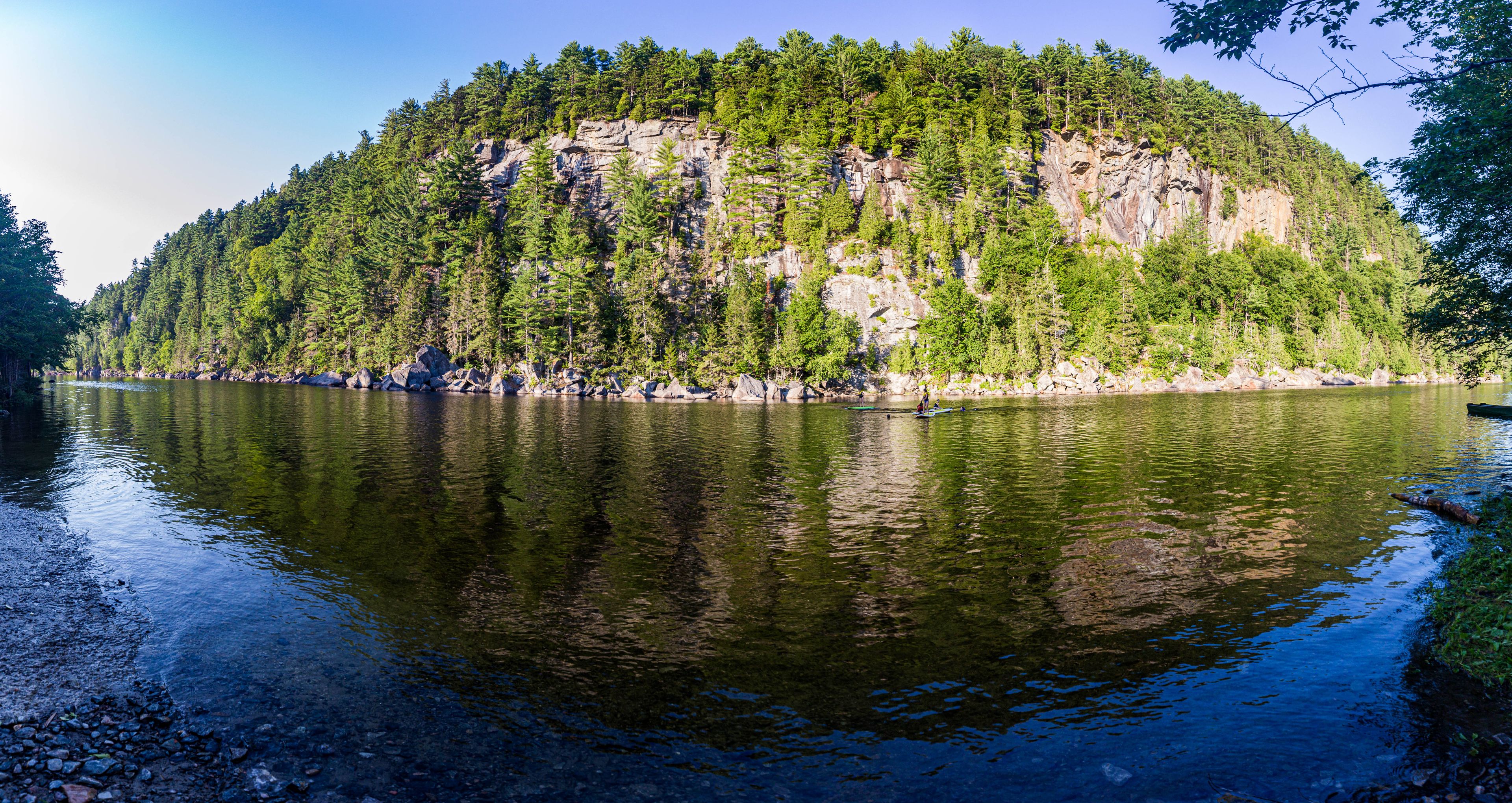 A calm lake with a forested island in the center.