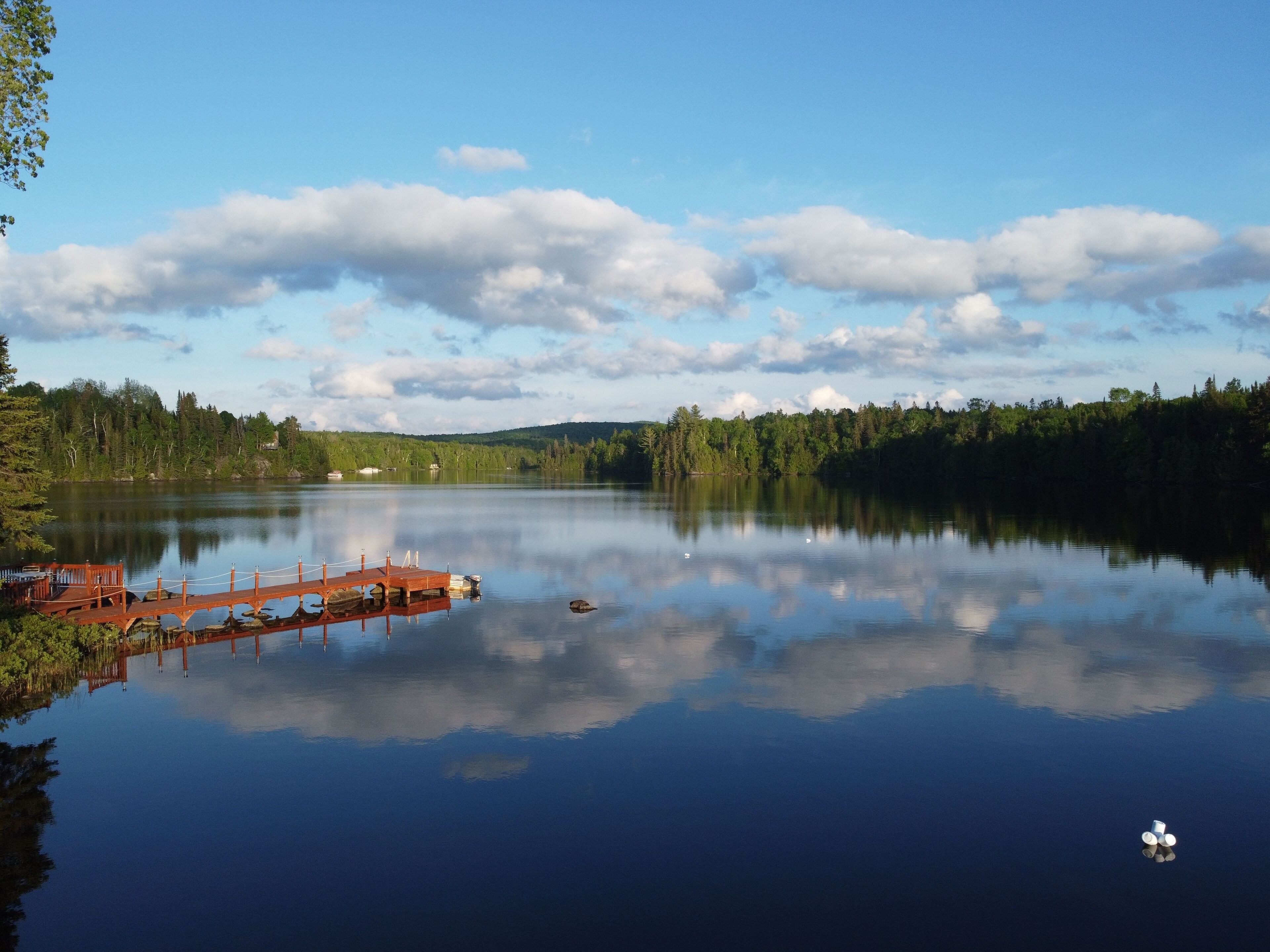 Scenic view of a wooden pier on Great Bays Lake in Nominingue, Quebec