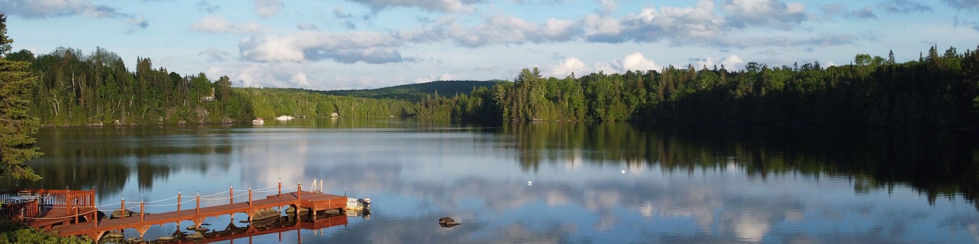 Scenic view of a wooden pier on Great Bays Lake in Nominingue, Quebec