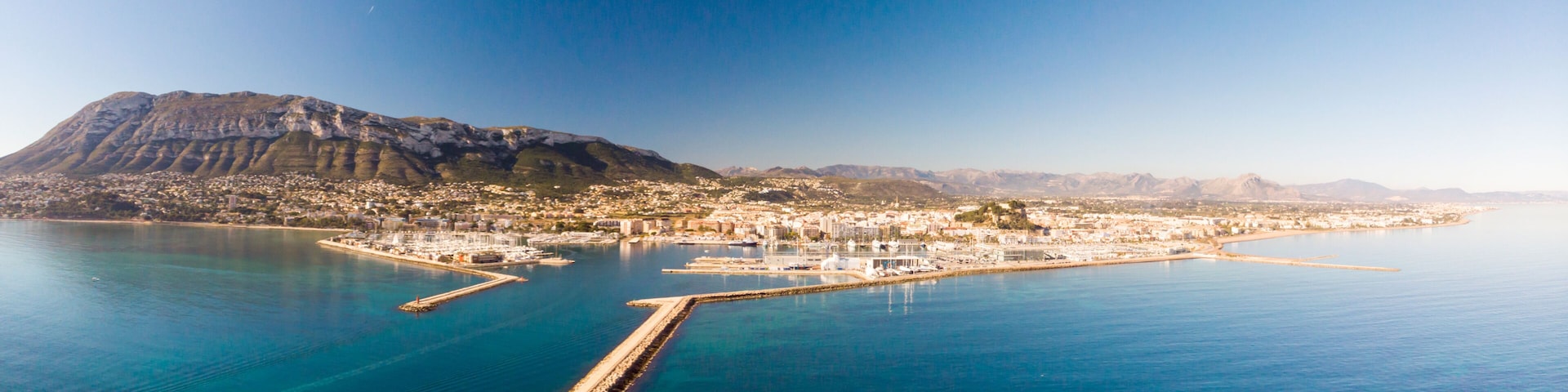 Aerial view of Denia port. The city and Montgo and Segaria mountains are in the background.