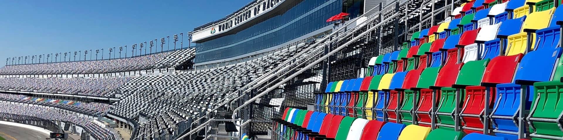A stadium with empty seats and a clear blue sky.