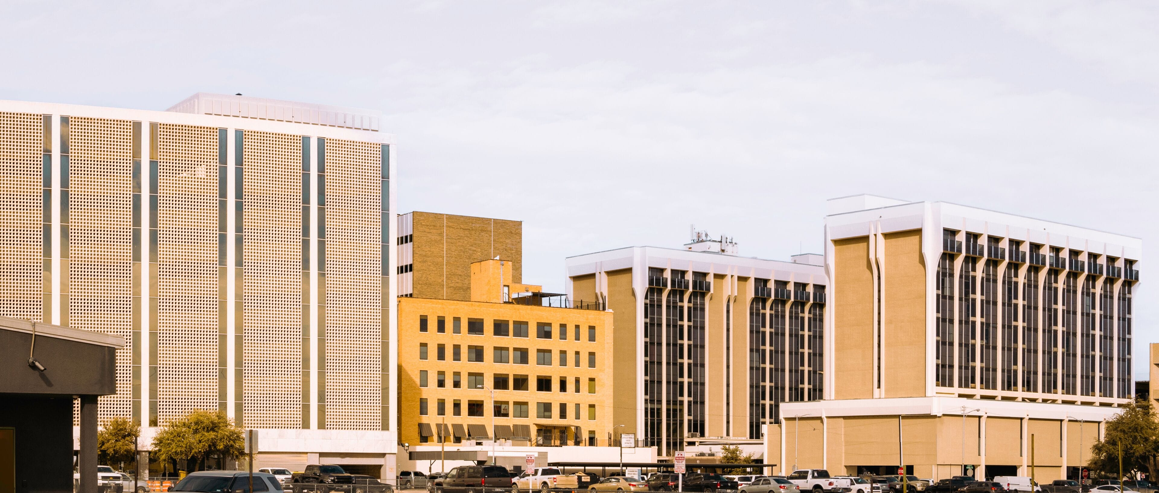 Modern Midland Texas city skyline and downtown skyscrapers, monochromatic gold, and brown tones