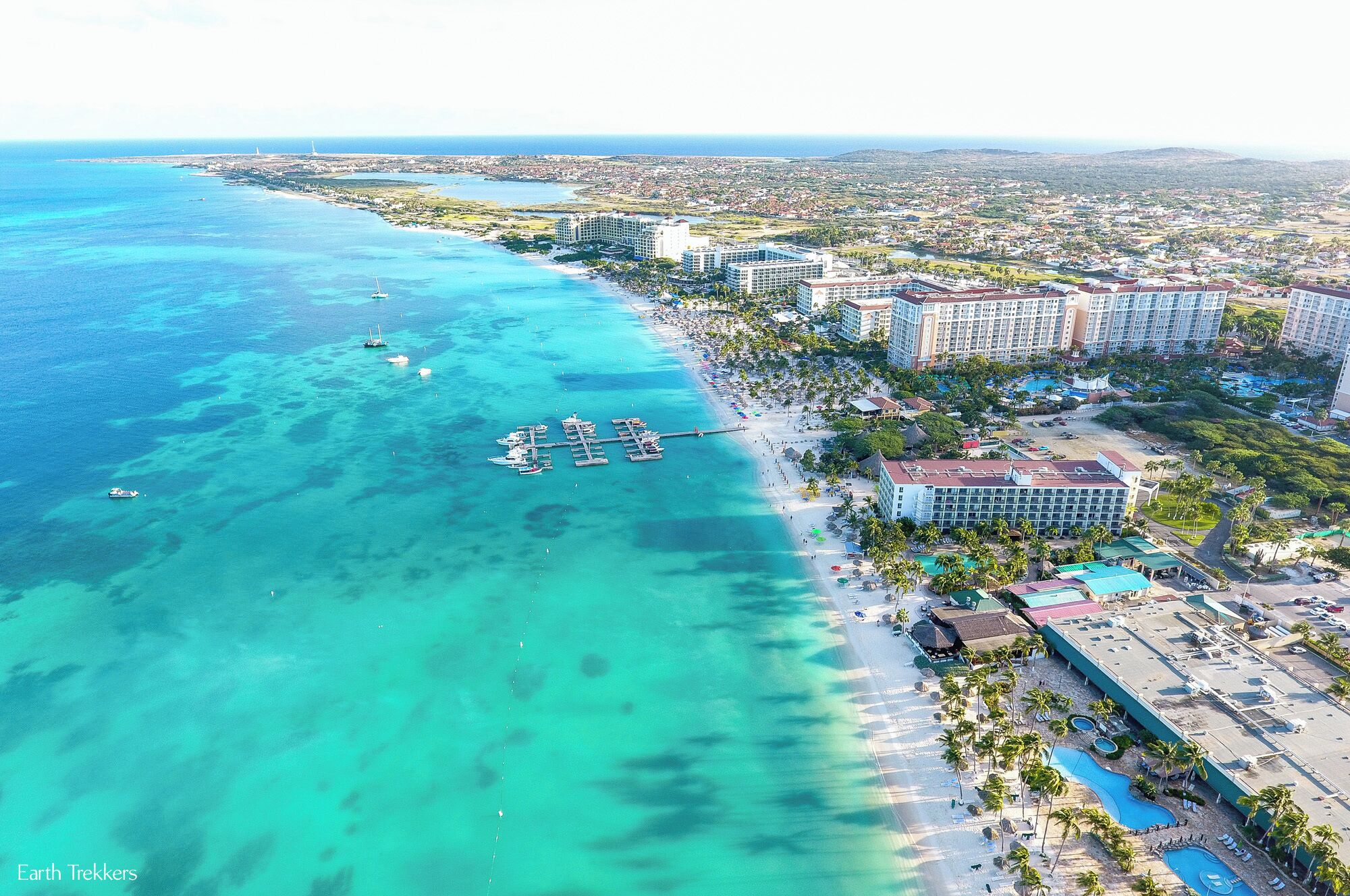 The beaches in Aruba are gorgeous! This is Palm Beach, where most of the high rise resorts are found. In this view is the Holiday Inn, Marriott, the Ritz and more, and off in the distance is the northern coast of Aruba. This photo was taken with our #drone. 

Read more about the beaches in Aruba: http://www.earthtrekkers.com/top-ten-best-beaches-in-aruba/