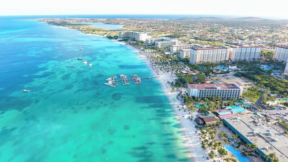 The beaches in Aruba are gorgeous! This is Palm Beach, where most of the high rise resorts are found. In this view is the Holiday Inn, Marriott, the Ritz and more, and off in the distance is the northern coast of Aruba. This photo was taken with our #drone.
Read more about the beaches in Aruba: http://www.earthtrekkers.com/top-ten-best-beaches-in-aruba/