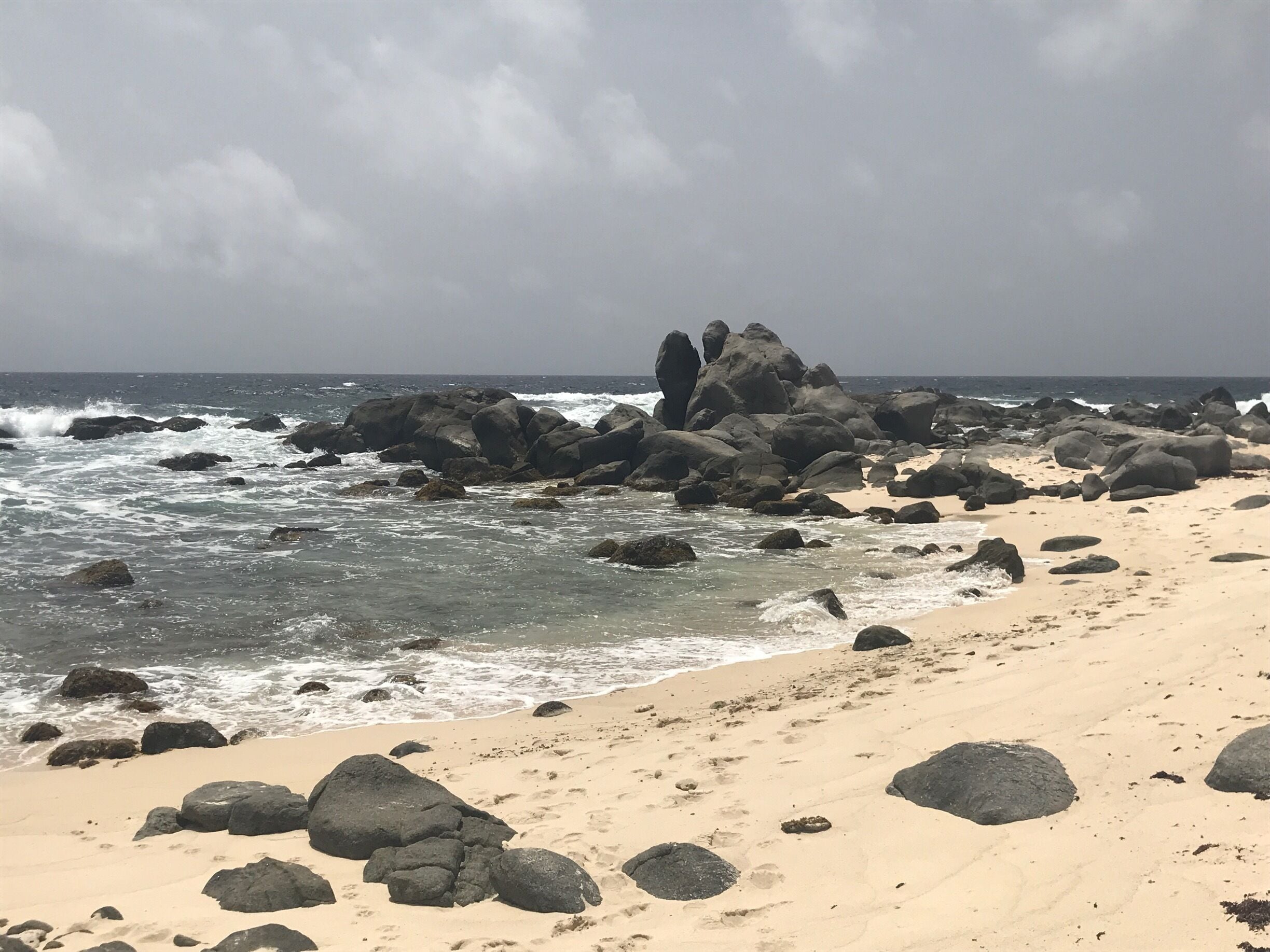 Black rocks beach at eastern coast in Aruba.