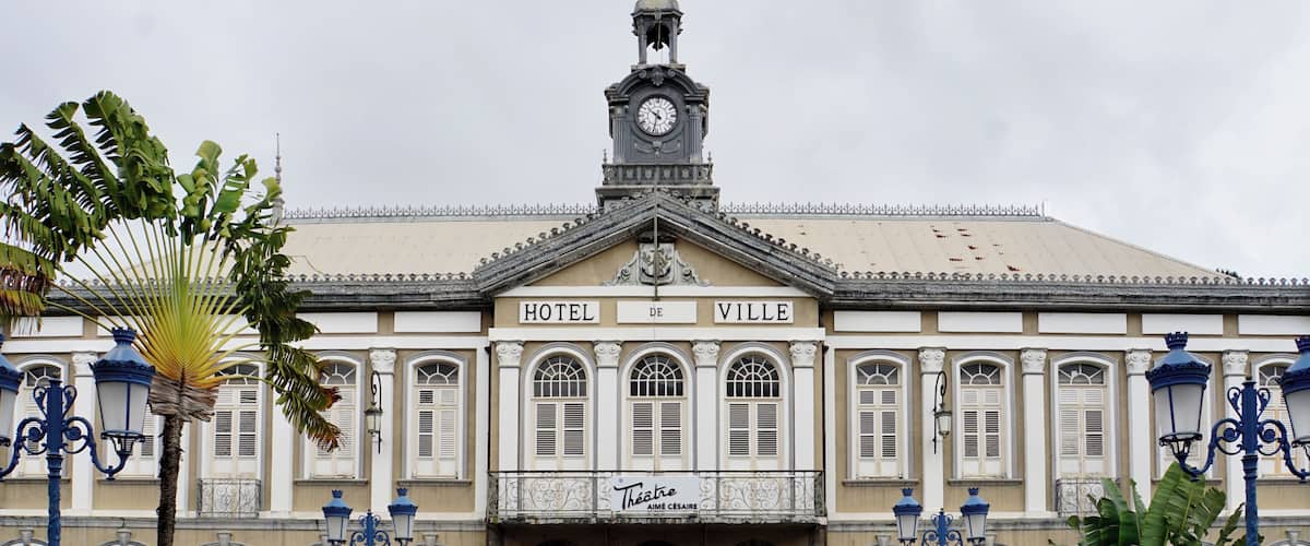 A historic building with a clock tower, named Hotel de Ville, featuring classical architecture and a central entrance.
