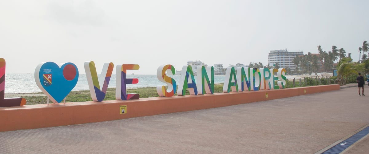 A colorful sign with the words "I LOVE SAN ANDREAS" along a coastal walkway.