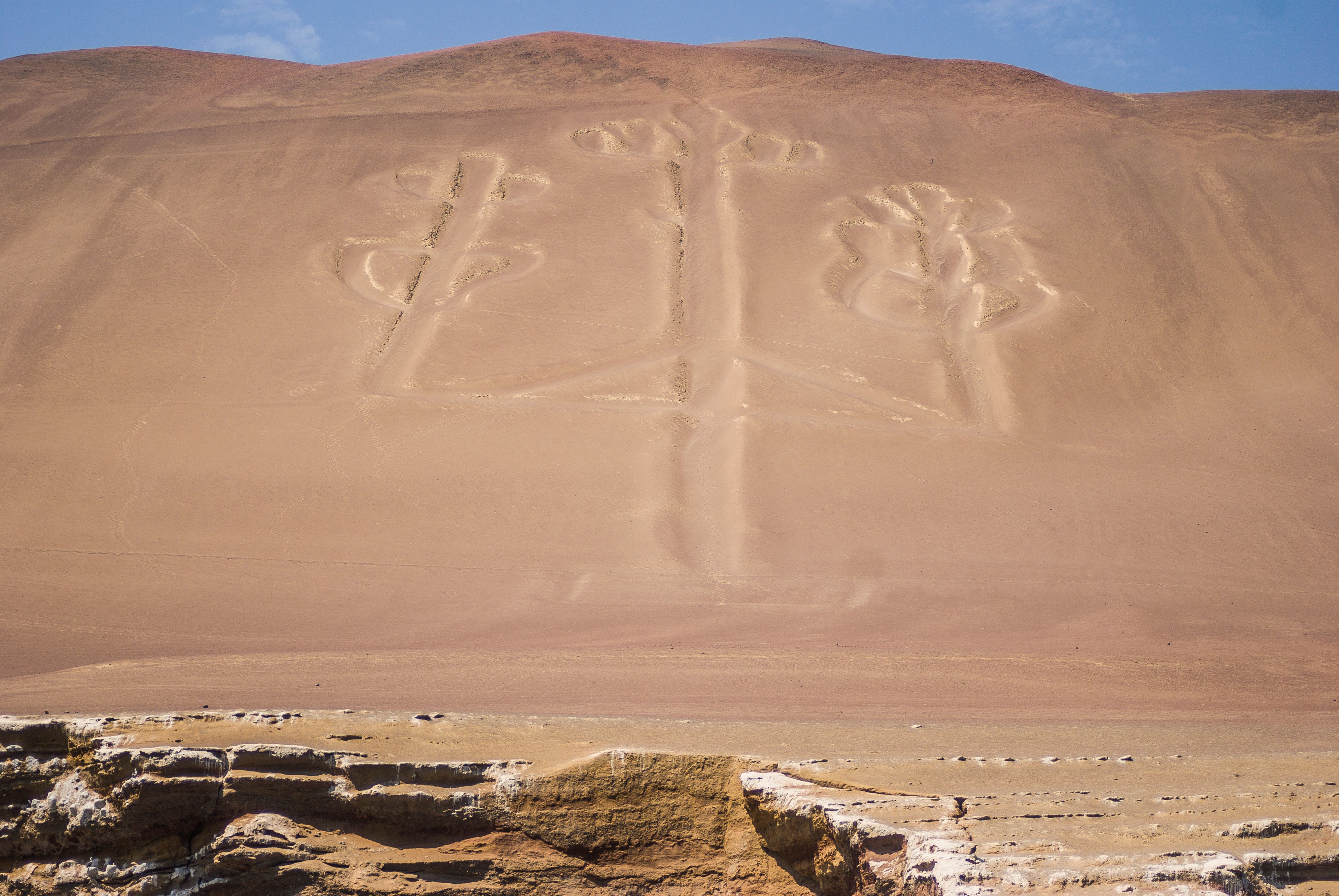 A desert landscape with large rock formations and a clear sky.