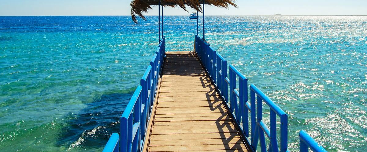 Egypt, Safaga, Africa, A luxurious pier in the middle of the turquoise Red Sea. Wonderful hot day, vacation on the beach.