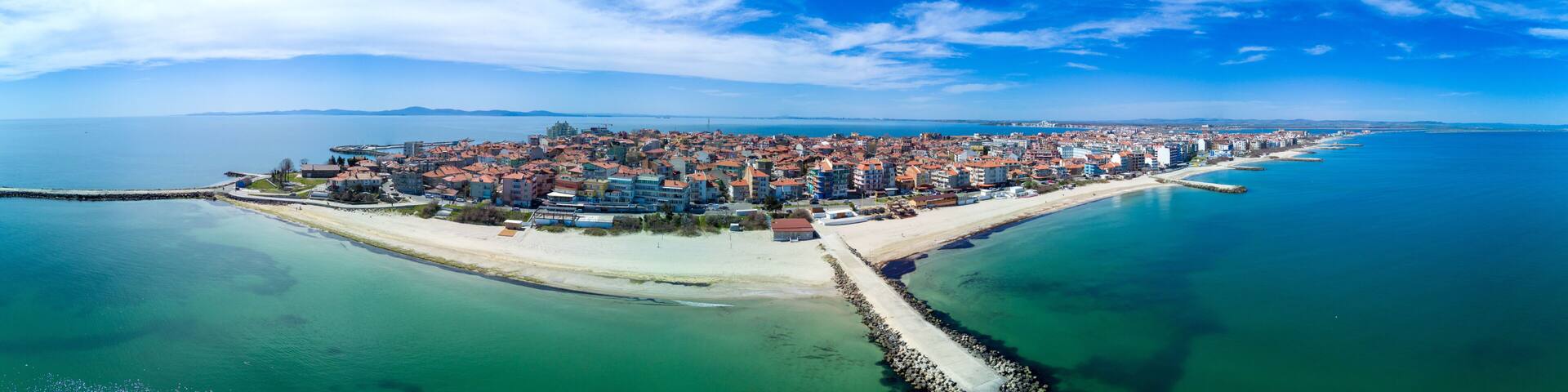 Panoramic view from a height above the town of Pomorie with houses and streets washed by the Black Sea in Bulgaria