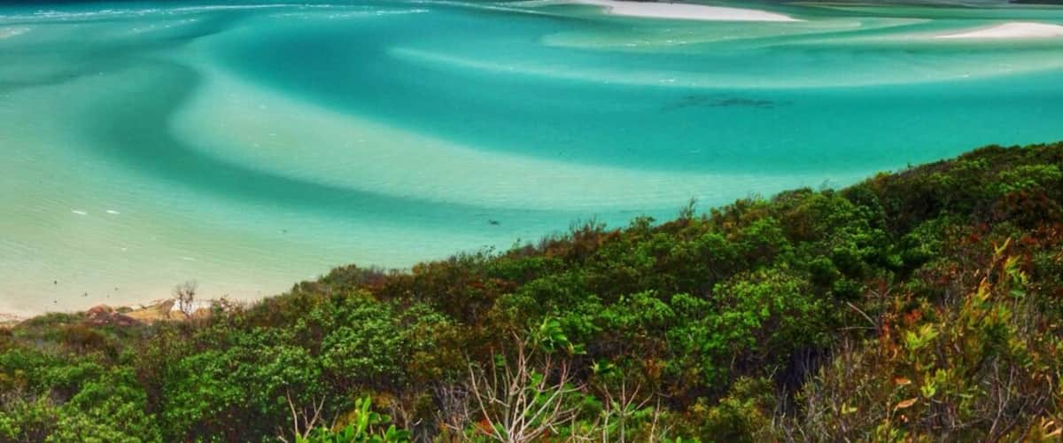 Whitehaven beach is one of the most beautiful beaches in the world. Located in the Whitsundays in Queensland, it's a 2 hour boat ride from the mainland. A great day trip from Airlie Beach, you can also camp on some of the surrounding islands, if you have your own boat.